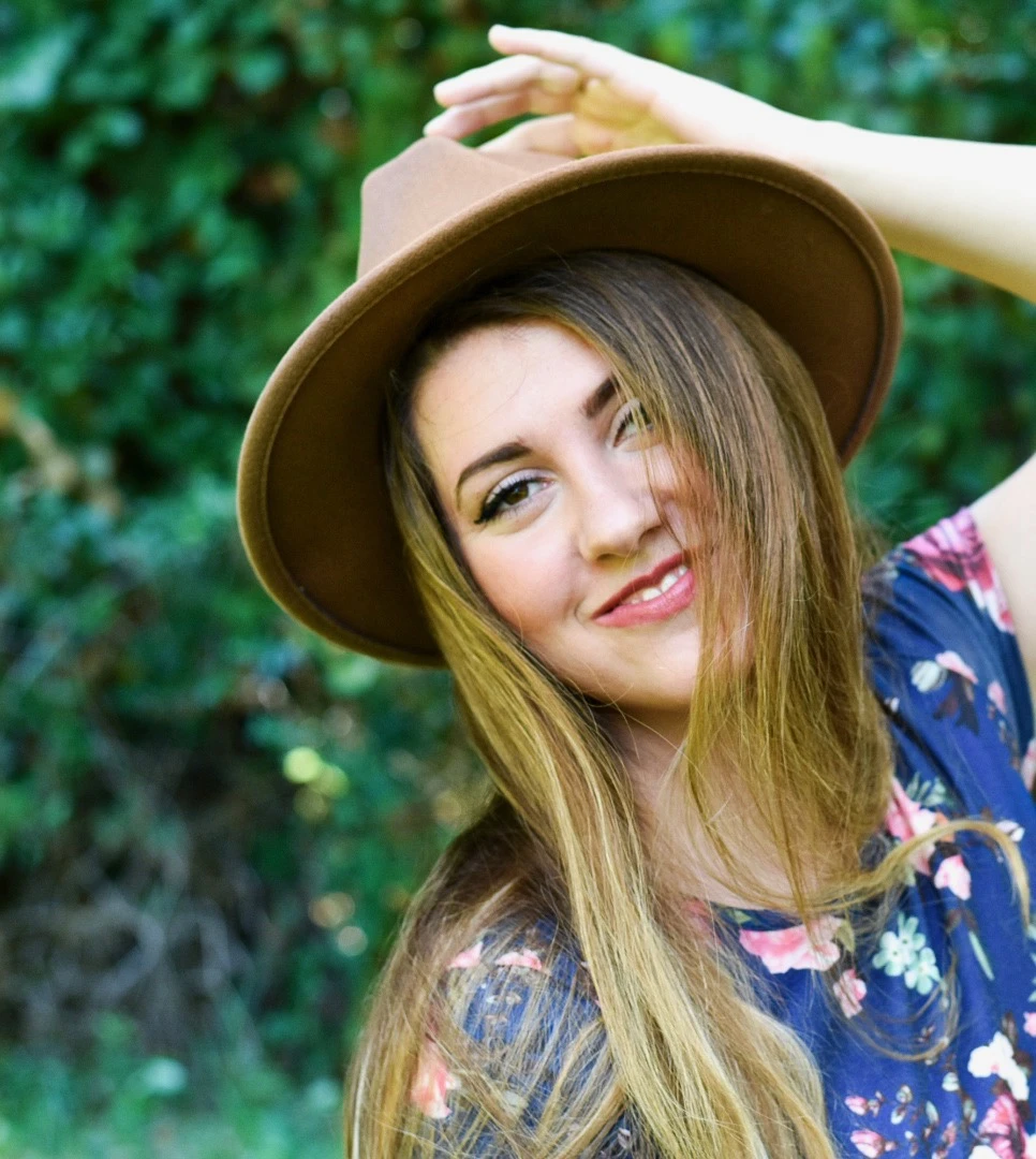 Madisen outdoors wearing a brown hat